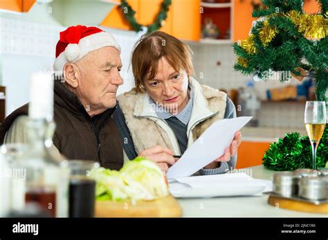 Mature Couple Sitting With Financial Documents Before Christmas Dinner Stock Photo Alamy