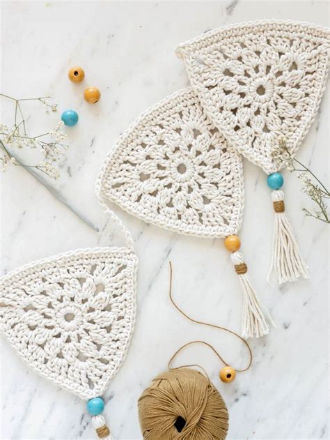 Two Crocheted Doily With Balls Of Yarn And Beads Next To Them On A