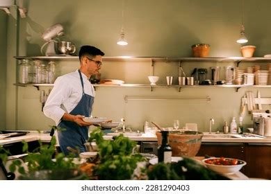 Male Chef Holding Plates While Working Stock Photo 2281290403