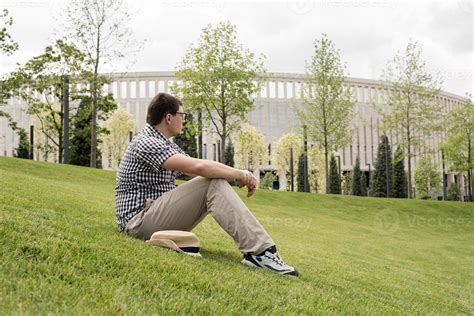 Young Thoughtful Man Sitting On The Grass In The Park 3307039 Stock