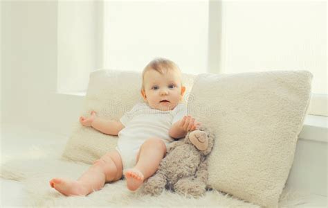 Happy Cute Little Baby Playing with Teddy Bear Toy in White Room at ...