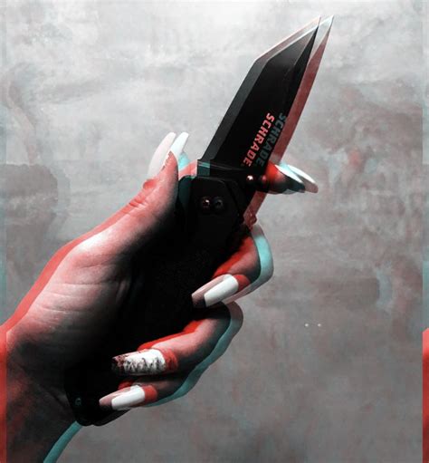 a person holding a knife in their hand with red and white designs on the blades