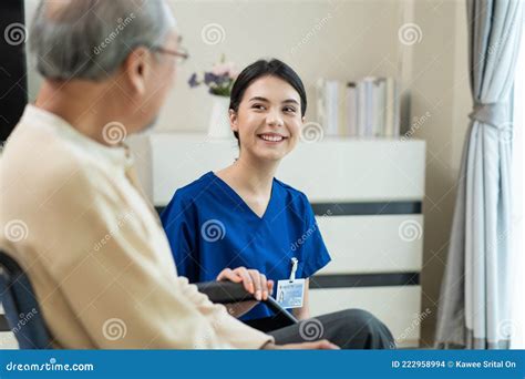 Asian Attractive Nurse Taking Care Of Mature Senior Elderly Male