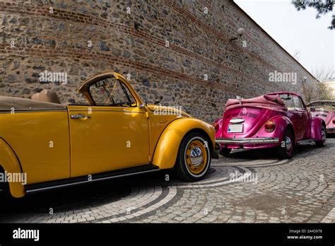 Yellow And Purple Colored Classic Convertible Cars Side View Stock