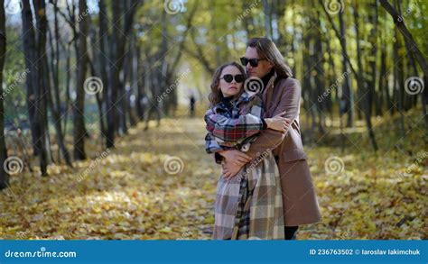 Embrace Of Heterosexual Loving Couple In Autumn Park Man Is Hugging