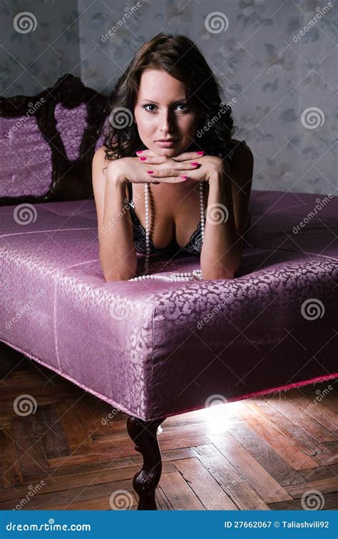 Girl In Retro Lingerie Lying On A Pink Sofa Stock Image Image Of