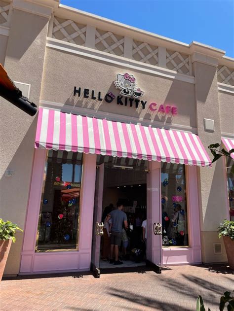 a pink and white striped awning on the front of a store