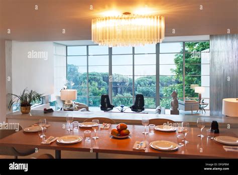 Place settings on table of modern dining room Stock Photo - Alamy