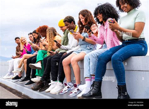 Happy Playful Multiethnic Group Of Young Friends Bonding Outdoors