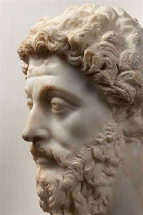 A Marble Bust Of A Man With Curly Hair And Beard