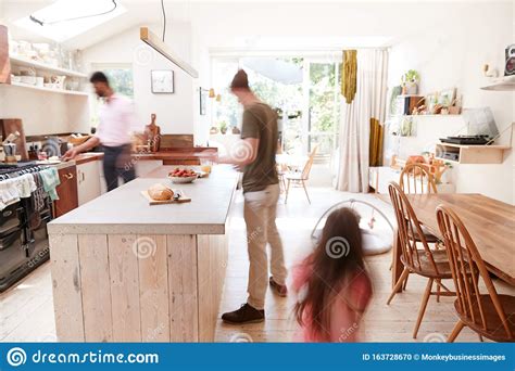 Same Sex Male Couple With Daughter Making Breakfast At Home Together Stock Photo Image Of