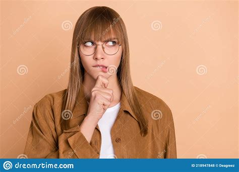 Photo Of Minded Thoughtful Young Woman Look Empty Space Hold Hand Chin Bite Lip Isolated On