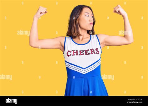 Young Beautiful Chinese Girl Wearing Cheerleader Uniform Showing Arms