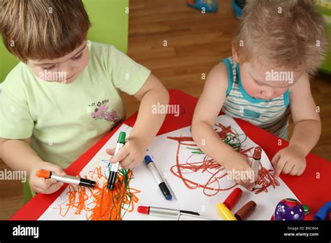 two children drawing Stock Photo - Alamy