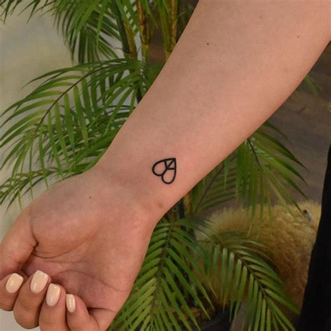 Heart Shaped Peace Symbol Tattoo On The Wrist