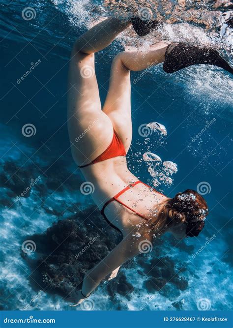 Woman In Bikini Dive Underwater In Tropical Blue Ocean Stock Image