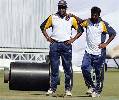 Chaminda Vaas And Muttiah Muralitharan Have A Look At The Pitch