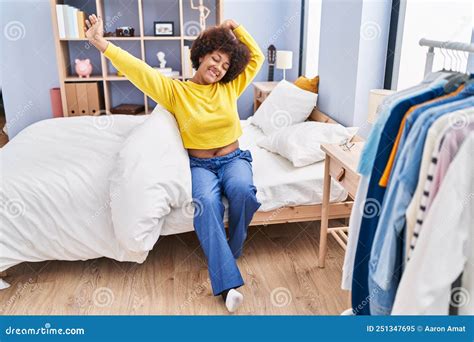 African American Woman Waking Up Stretching Arms At Bedroom Stock Image