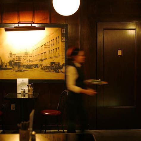 A Woman Walking Past A Painting In A Restaurant