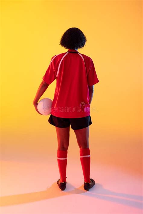 Rear View Of African American Female Rugby Player With Rugby Ball Over