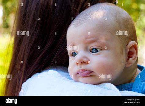 Portrait Of Beautiful Baby In Loving Mother S Arms Newborn Head Is