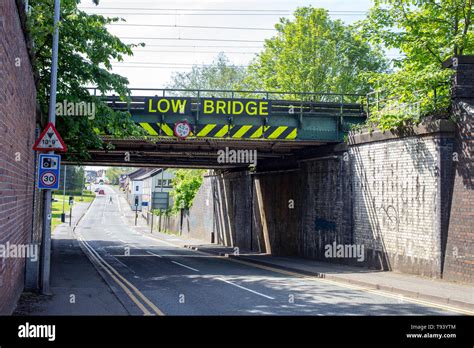 Low bridge warning sign on railway bridge in Cheshire UK Stock Photo - Alamy