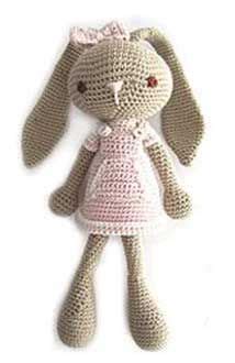 A Crocheted Bunny Doll With A Pink Dress