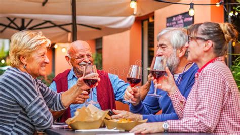 Group Of Old People Eating And Drinking Outdoor Senior Couples Having