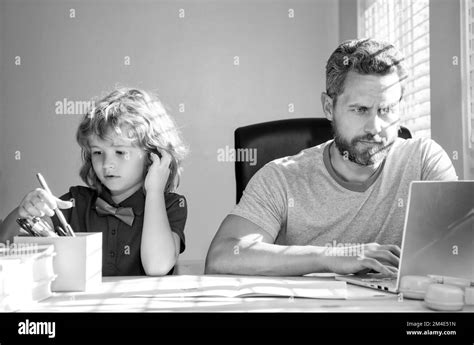 Mature Man Teacher Or Dad Helping Kid Son With School Homework On Computer Homeschooling Stock