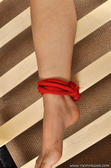 Naked Teen Is Silenced With Duct Tape While Restrained To A Bed Frame