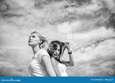 Feeling Free And Happy Girls On Cloudy Sky Adorable Women With Blond And Brunette Hair
