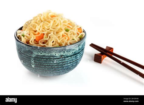 Instant Noodles Bowl With Carrot And Scallions With Chopsticks On A