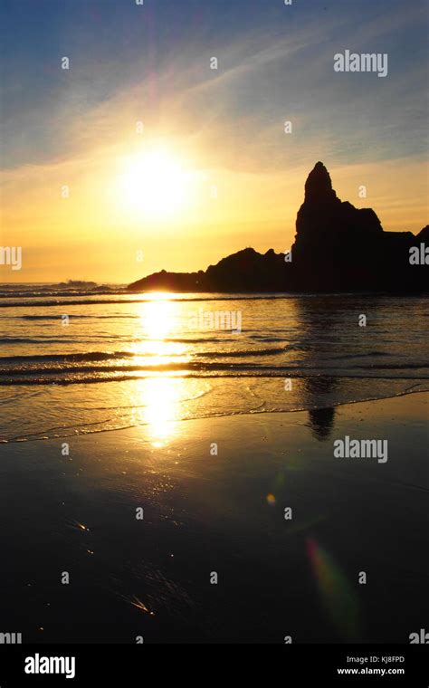 sunset at piha beach, new zealand Stock Photo - Alamy