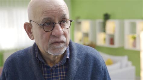 Worried Thoughtful Old Adult Man At Home Alone In Front Of Mirror