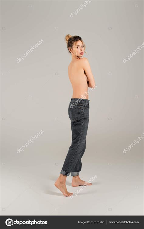 Full Length Slender Half Naked Woman Jeans Standing Barefoot Looking Stock Photo