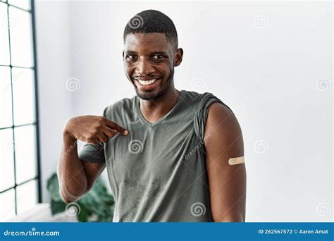 Young African American Man Getting Vaccine Showing Arm With Band Aid