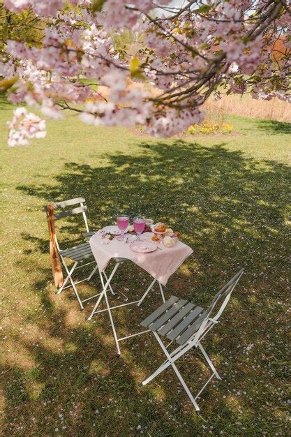 Premium Photo | A table and chairs under a cherry blossom tree