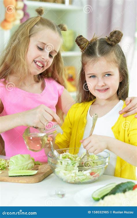 Portrait Of Cute Girls Preparing Delicious Fresh Salad Stock Image