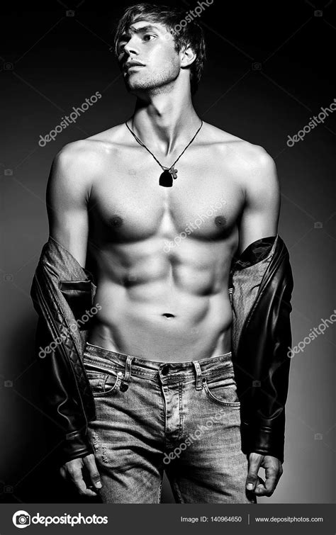 Muscled Fit Male Model Man Posing In Studio Showing His Abdominal