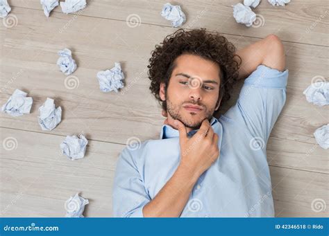 Man With Crumpled Papers Lying On Floor Stock Photo Image Of Crumpled