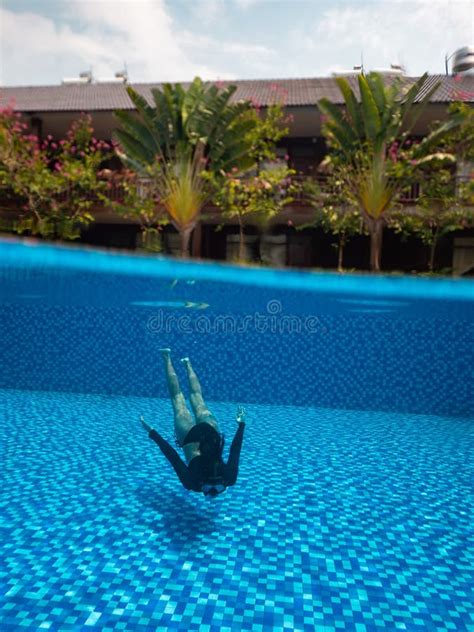 A Young Woman In Bikini And Snorkel Mask Underwater In Pool And A