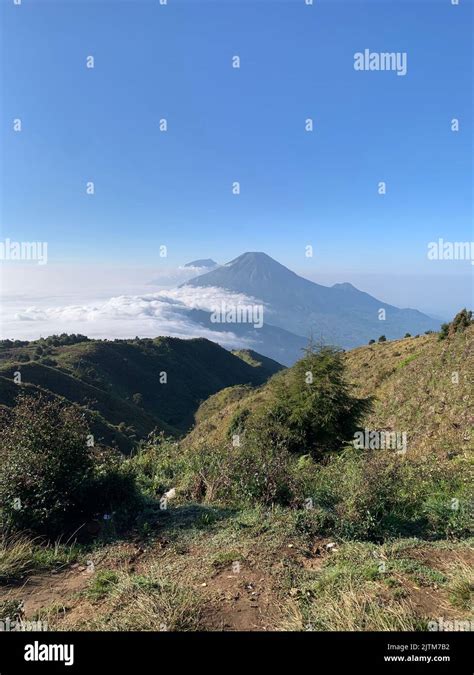 A Vertical View Of Mount Prau With Mount Sindoro And Mount Sumbing In