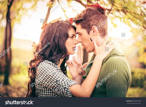 Young Heterosexual Couple In Love In Park In The Autumn Landscape