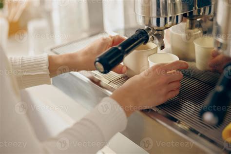 Close up of barista use coffee machine filling a two cups with espresso