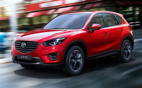 A Red Mazda Cx 5 Driving Down The Street