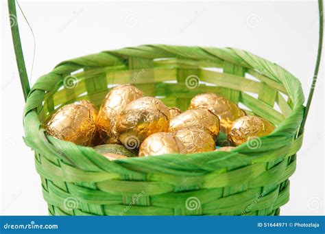 Chocolate Golden Easter Egg in Green Basket Stock Image - Image of ...