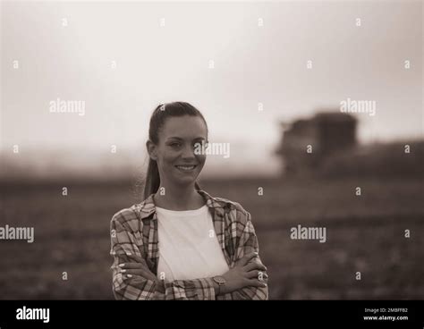 Portrait Of Pretty Farmer Woman Standing In Corn Field With Crossed