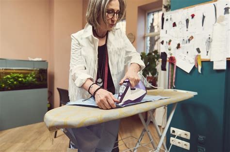 Premium Photo Fashion Designer Tailor Using Steam Iron To Press Blue