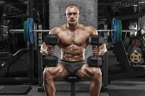 Muscular Man With Dumbbells In Gym Bodybuilder Strong Male Naked Torso Abs Working Out Stock