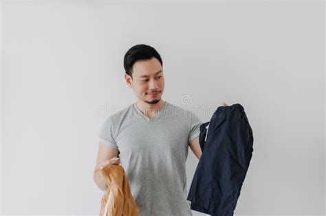 Man Choosing A New Short Pants To Wear Isolated On White Stock Photo